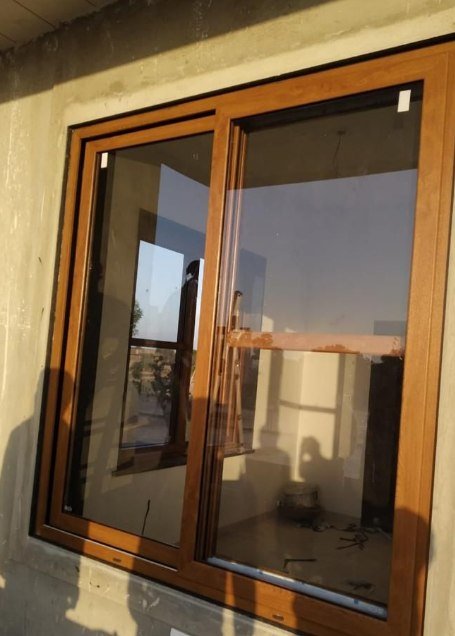 Golden Oak sliding window freshly fitted in a new building