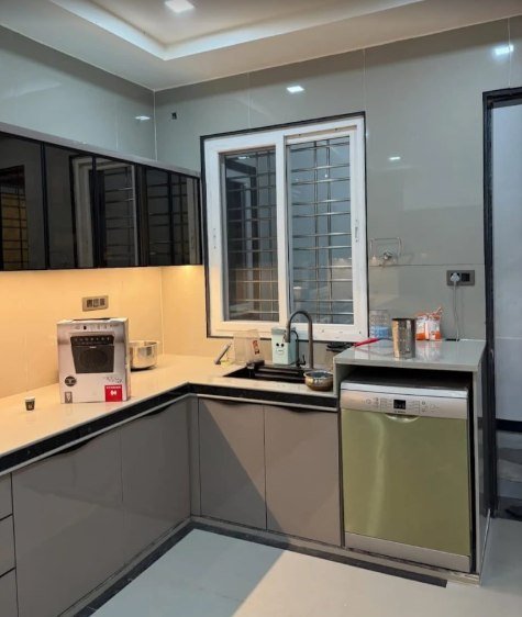 White sliding window with a safety grill above a kitchen counter