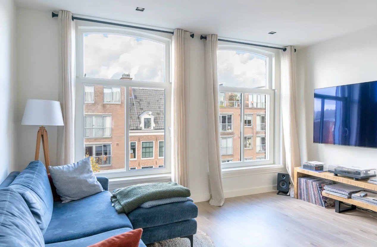 Living room with two tall white arched windows