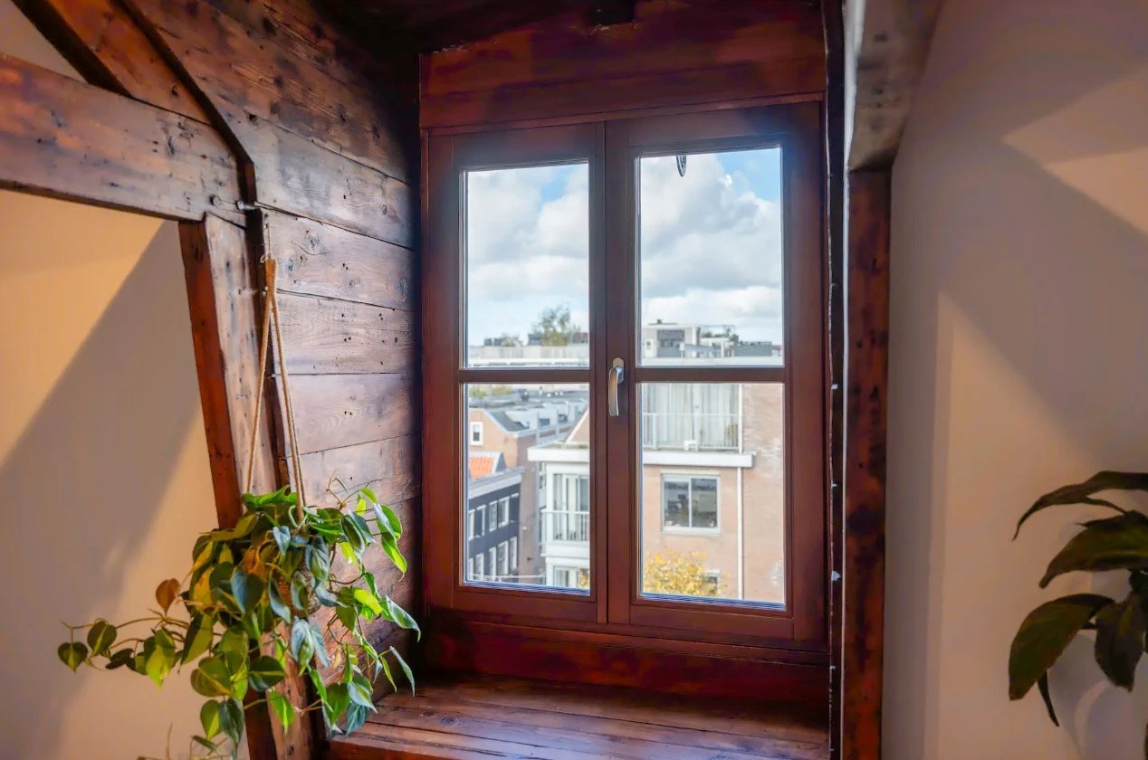 Wood-finish double casement window in an attic room